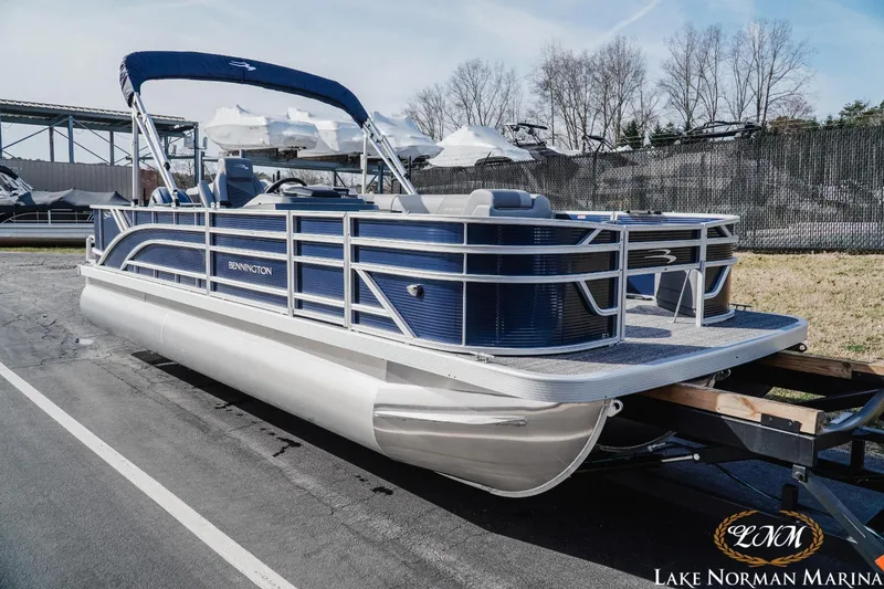 Slide: The Image of 2024 Bennington 22SF-SPS pontoon boat on trailer at Lake Norman Marina. - 2