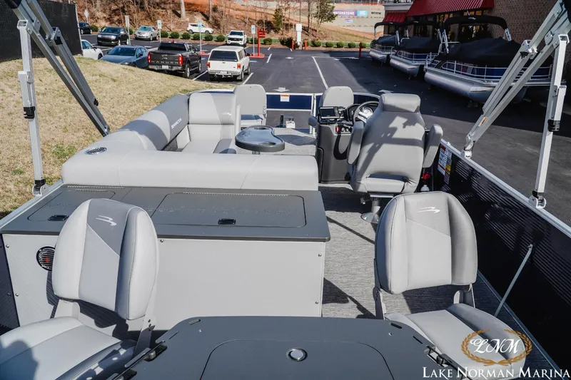 Slide: The Image of 2024 Bennington 22SF-SPS pontoon boat interior with gray seating and helm at Lake Norman Marina. - 5