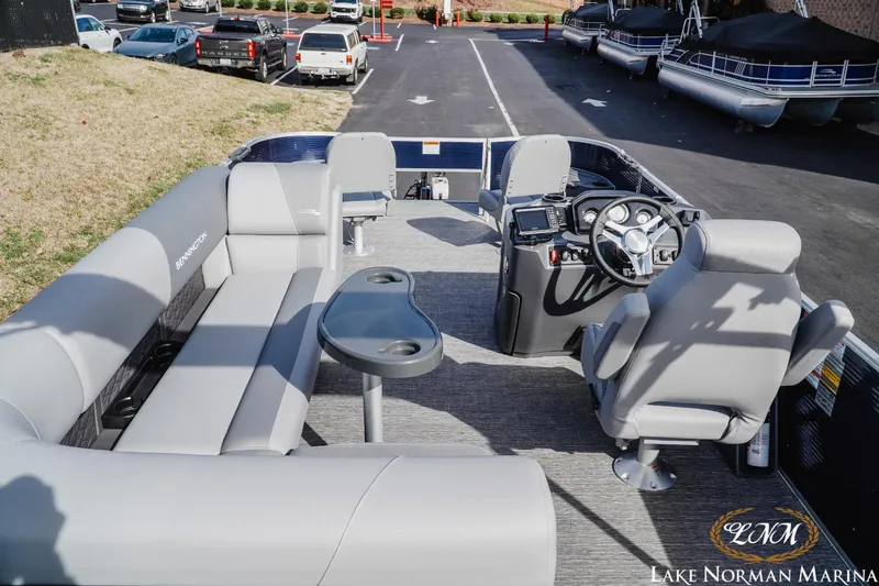 Slide: The Image of 2024 Bennington 22SF-SPS pontoon boat interior with seating and steering console at Lake Norman Marina. - 6