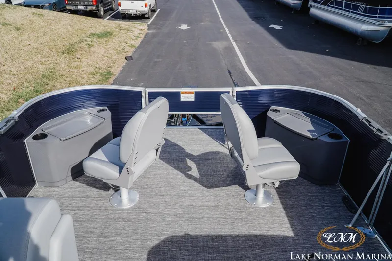 Slide: The Image of 2024 Bennington 22SF-SPS pontoon boat interior with seating and storage at Lake Norman Marina. - 7