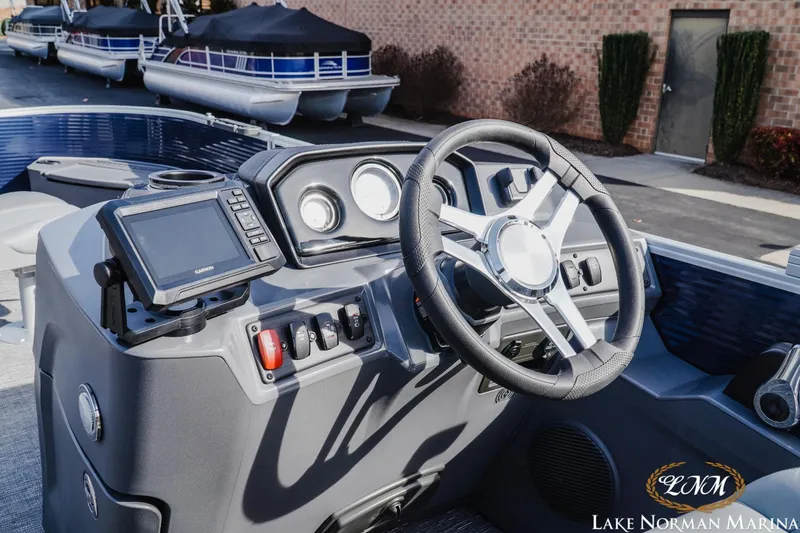 Slide: The Image of 2024 Bennington 22SF-SPS boat dashboard with steering wheel and navigation system at Lake Norman Marina. - 9