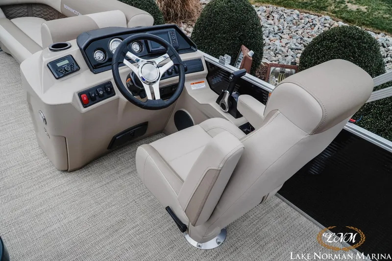 Slide: The Image of 2024 Bennington 22ss-sps boat helm with beige seating and modern controls. - 10