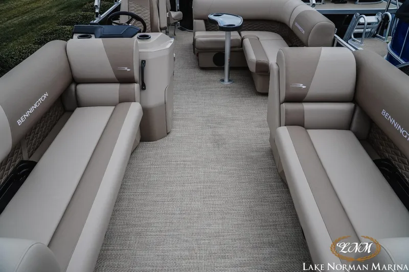 Slide: The Image of 2024 Bennington 22ss-sps pontoon boat interior with beige seating and steering console. - 12