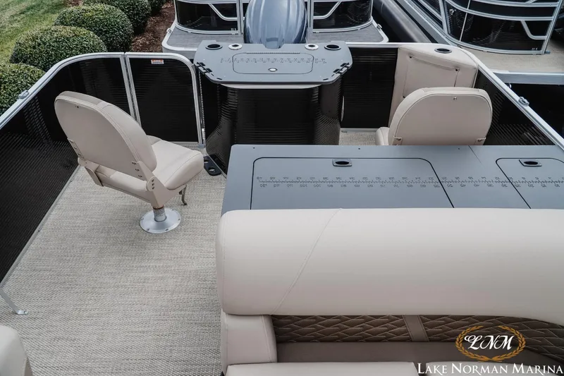 Slide: The Image of 2024 Bennington 22ss-sps pontoon boat interior with beige seating and helm at Lake Norman Marina. - 15
