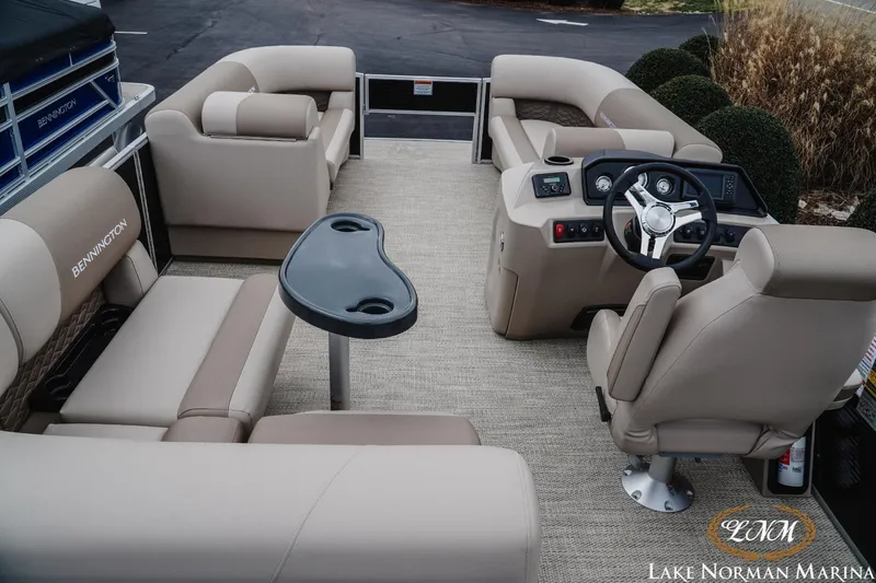 Slide: The Image of 2024 Bennington 22ss-sps pontoon boat interior with beige seating and steering console. - 8