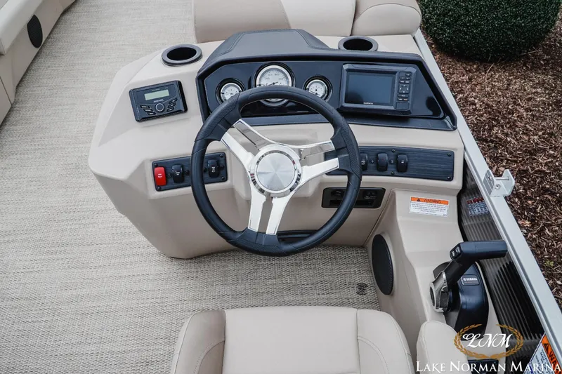 Slide: The Image of 2024 Bennington 22ss-sps boat dashboard with steering wheel and control panel. - 9