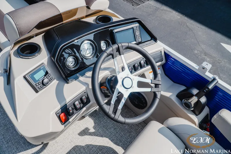 Slide: The Image of 2025 Bennington 22SSR boat dashboard with steering wheel and control panel at Lake Norman Marina. - 10