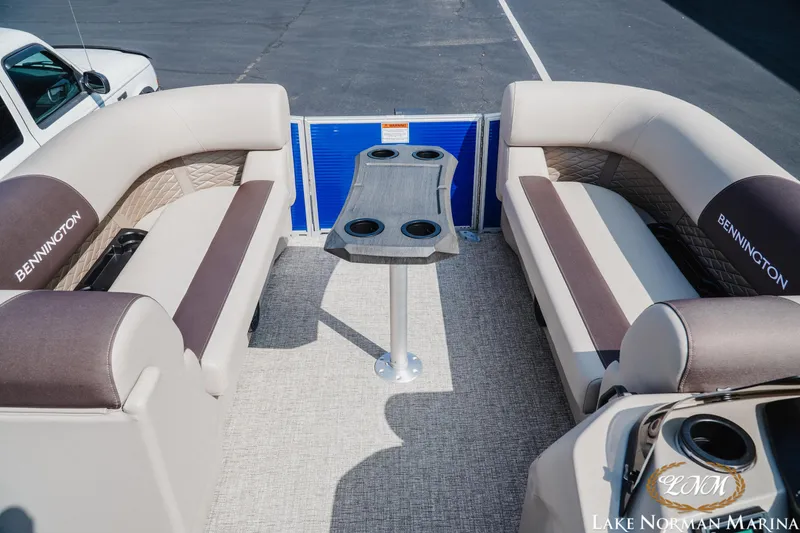 Slide: The Image of 2025 Bennington 22SSR boat interior with plush seating and central table. - 11