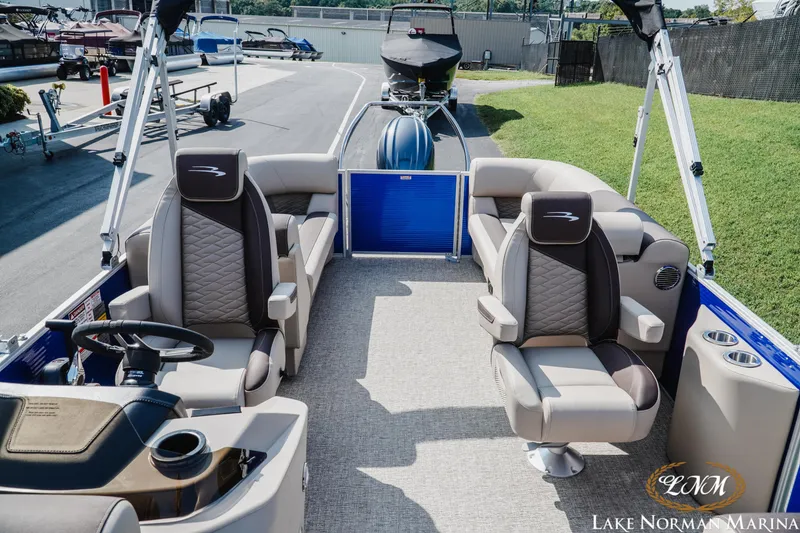 Slide: The Image of 2025 Bennington 22SSR pontoon boat interior with plush seating at Lake Norman Marina. - 14