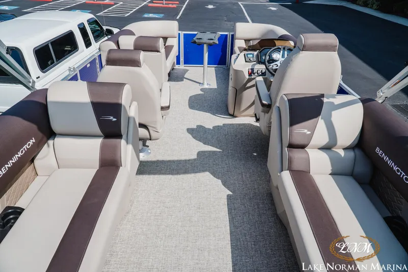 Slide: The Image of 2025 Bennington 22SSR pontoon boat interior with plush seating at Lake Norman Marina. - 5