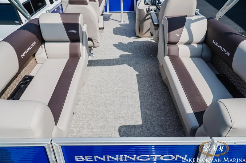 Slide: The Image of 2025 Bennington 22SSR pontoon boat interior with plush seating at Lake Norman Marina. - 6