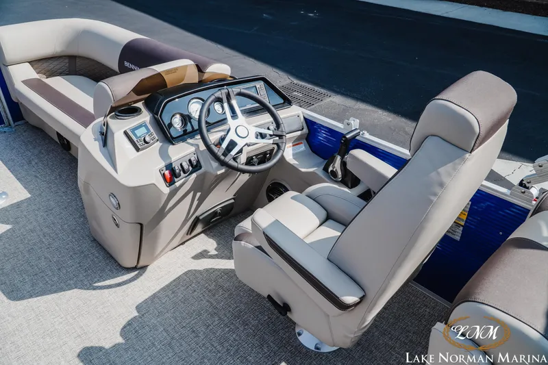 Slide: The Image of 2025 Bennington 22SSR boat interior with steering console and seating at Lake Norman Marina. - 8