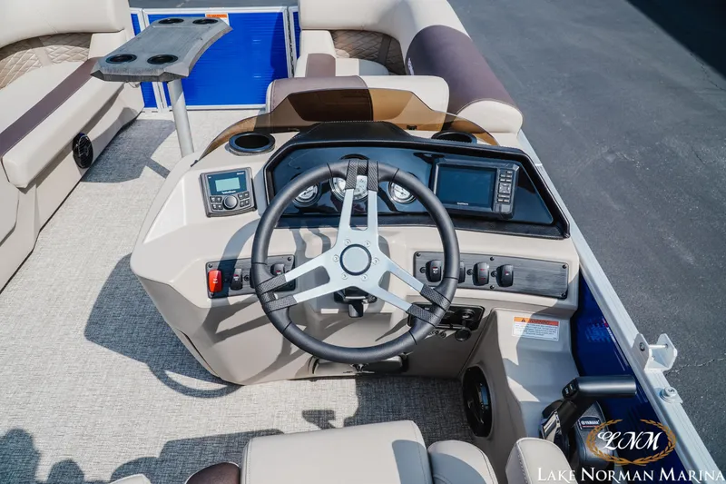 Slide: The Image of 2025 Bennington 22SSR boat helm with steering wheel and control panel at Lake Norman Marina. - 9