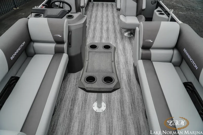 Slide: The Image of 2025 Bennington 22SSR pontoon boat interior with gray seating and central table. - 13