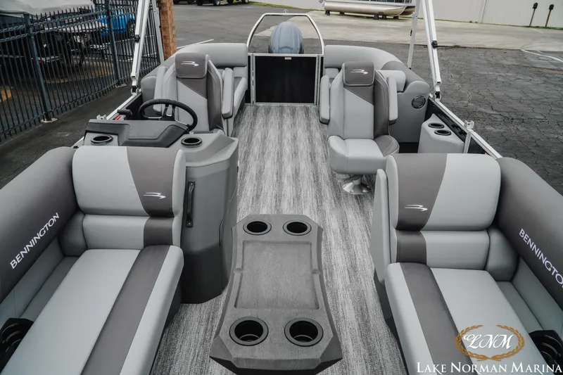 Slide: The Image of 2025 Bennington 22SSR pontoon boat interior with gray seating and cup holders at Lake Norman Marina. - 14