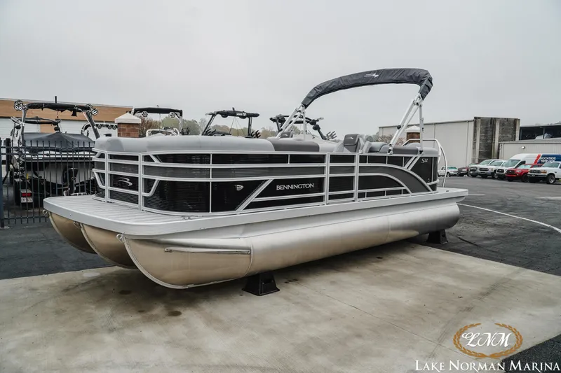 Slide: The Image of 2025 Bennington 22SSR pontoon boat at Lake Norman Marina, displayed outdoors. - 2