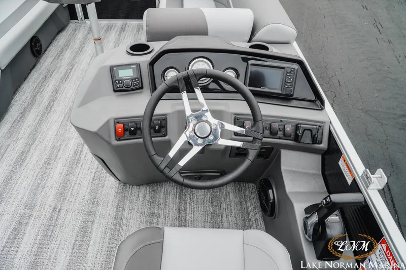Slide: The Image of 2025 Bennington 22SSR boat dashboard with steering wheel and control panel. - 9