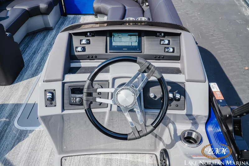 Slide: The Image of 2025 Bennington 23LSB boat dashboard with steering wheel and control panel. - 10