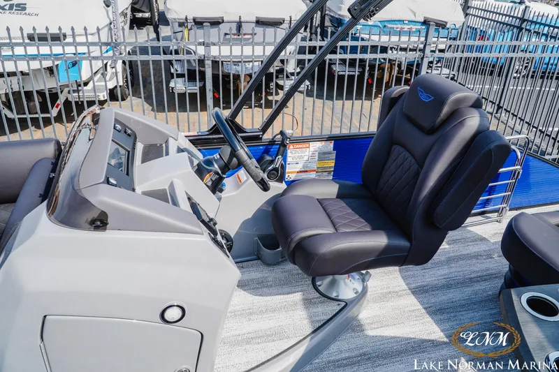 Slide: The Image of 2025 Bennington 23LSB boat interior with captain's chair and control panel at Lake Norman Marina. - 15