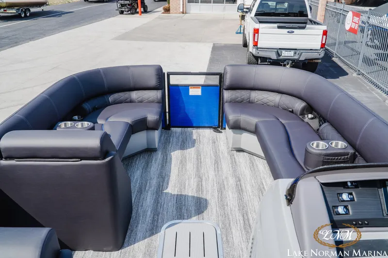 Slide: The Image of 2025 Bennington 23LSB pontoon boat interior with luxurious seating and cup holders at Lake Norman Marina. - 9