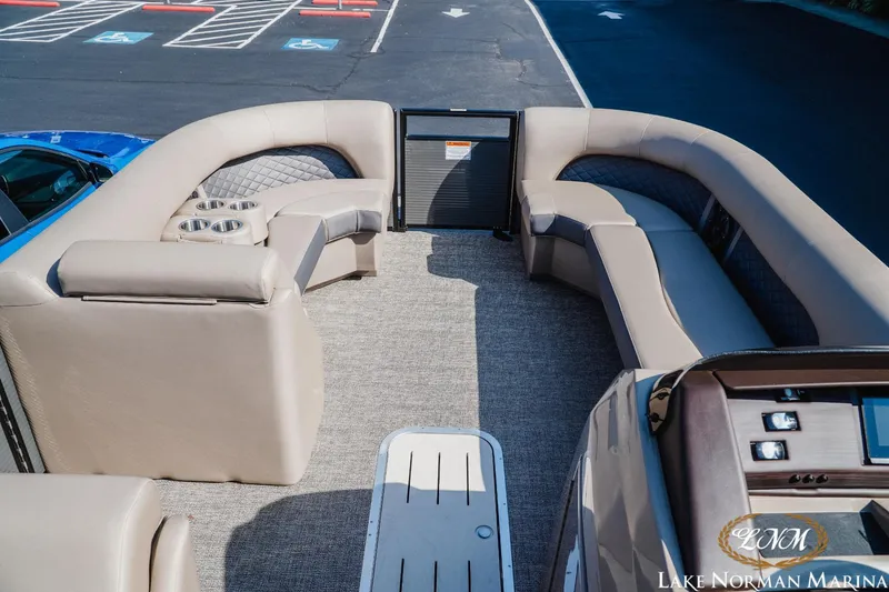 Slide: The Image of 2025 Bennington 23LSB pontoon boat interior with plush seating and cup holders. - 11