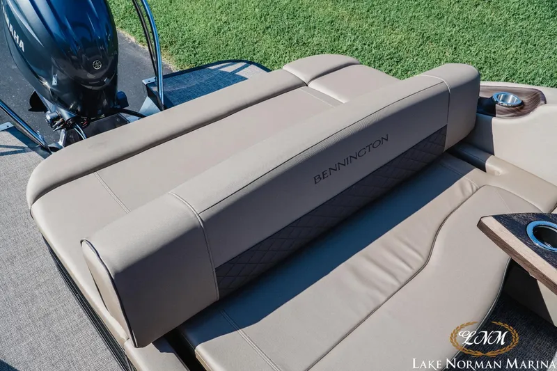 Slide: The Image of 2025 Bennington 23LSB boat interior with Yamaha engine, featuring luxurious seating and cup holders. - 15