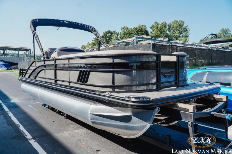 Slide: The Image of 2025 Bennington 23LSB pontoon boat on trailer at Lake Norman Marina. - 2