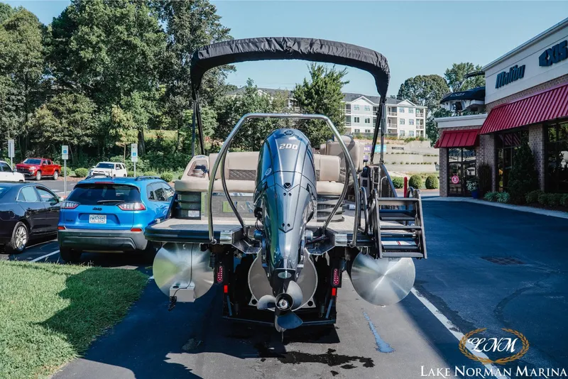 Slide: The Image of 2025 Bennington 23LSB pontoon boat with powerful outboard motor at Lake Norman Marina. - 4