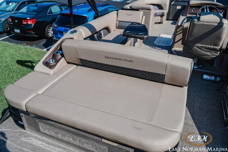 Slide: The Image of 2025 Bennington 23LSB boat interior with luxurious seating and cup holders at Lake Norman Marina. - 7