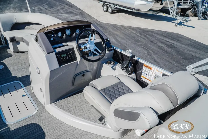 Slide: The Image of 2023 Bennington 23LSR boat interior with steering console and seating at Lake Norman Marina. - 10