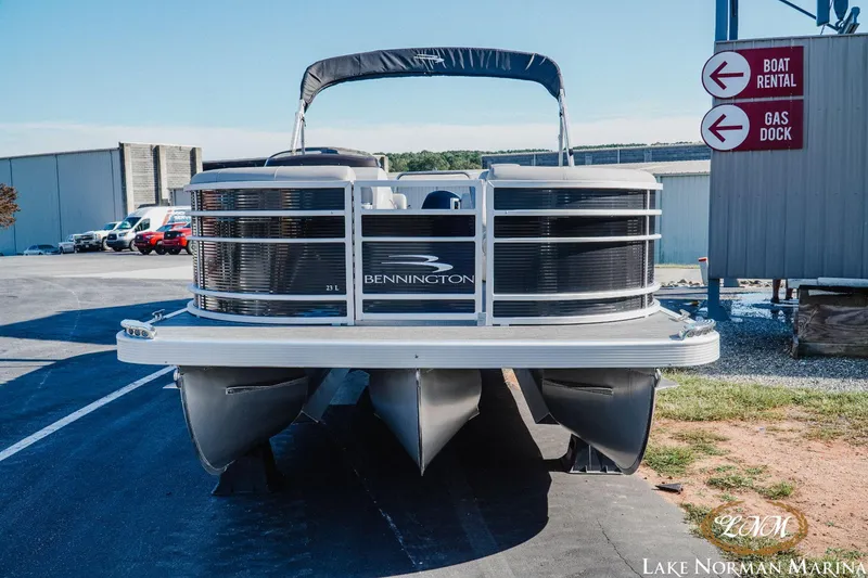 Slide: The Image of 2023 Bennington 23LSR pontoon boat at Lake Norman Marina, near boat rental and gas dock signs. - 4