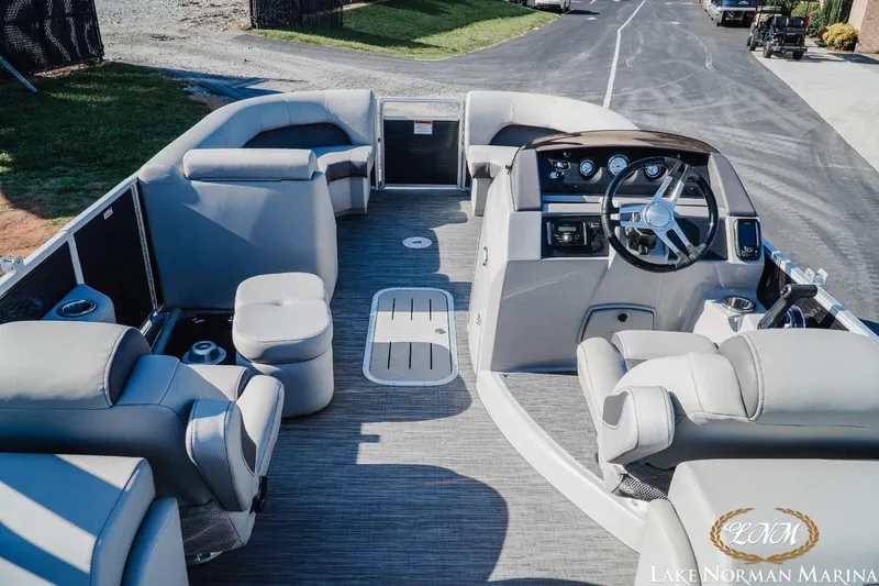 Slide: The Image of 2023 Bennington 23LSR pontoon boat interior with plush seating and modern helm. - 7