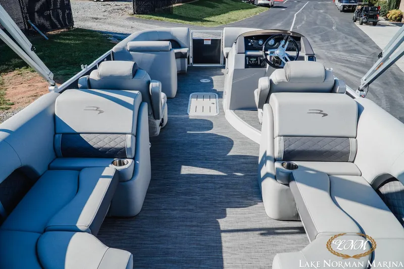 Slide: The Image of 2023 Bennington 23LSR pontoon boat interior with luxurious seating and modern dashboard. - 8