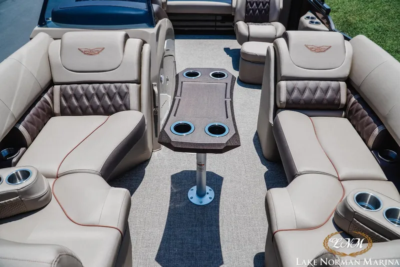 Slide: The Image of Luxurious interior of 2024 Bennington 23LXSSB pontoon boat with plush seating and table. - 12