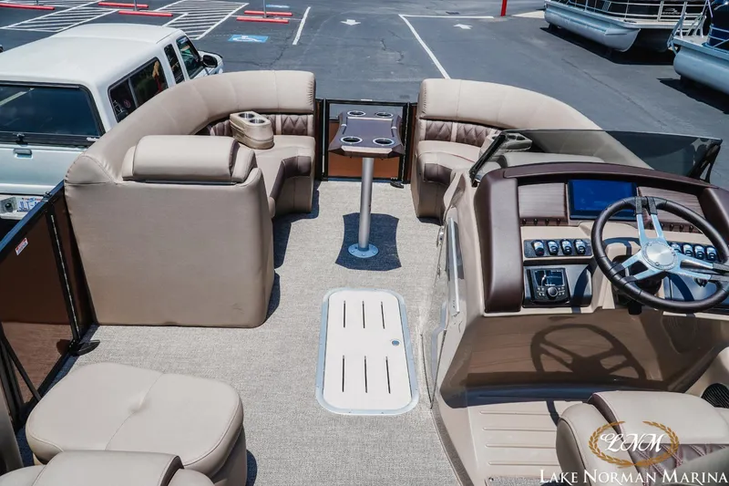 Slide: The Image of 2024 Bennington 23LXSSB pontoon boat interior with plush seating and modern helm. - 7