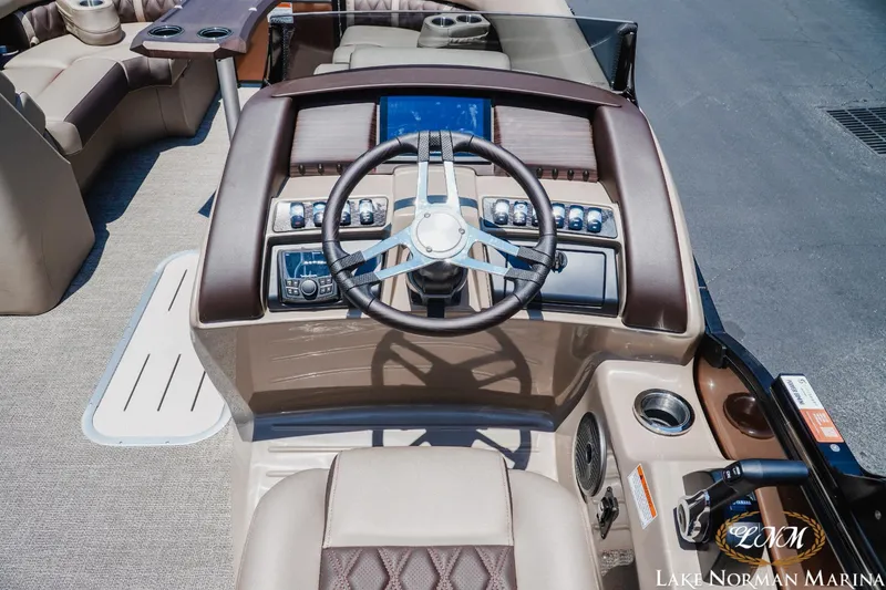 Slide: The Image of 2024 Bennington 23LXSSB boat dashboard with steering wheel and controls at Lake Norman Marina. - 9