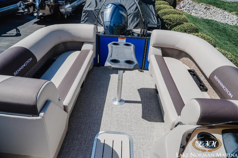 Slide: The Image of 2025 Bennington 23SSB pontoon boat interior with seating and table, Lake Norman Marina. - 11