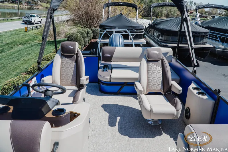 Slide: The Image of 2025 Bennington 23SSB pontoon boat interior with plush seating at Lake Norman Marina. - 13