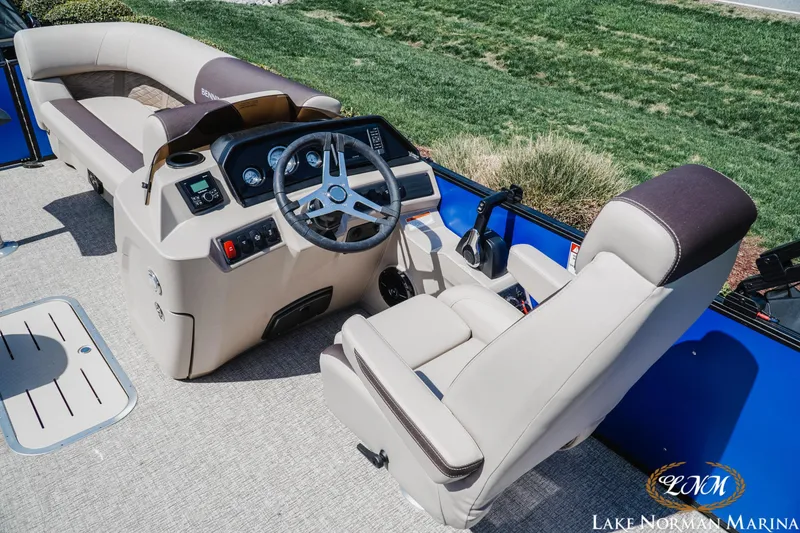 Slide: The Image of 2025 Bennington 23ssb boat interior with steering console and seating at Lake Norman Marina. - 8