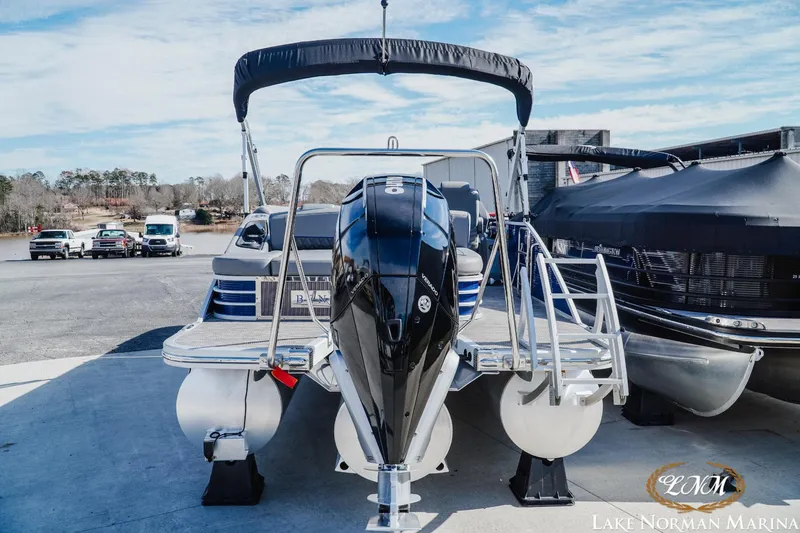 Slide: The Image of 2023 Bennington 24LXSB pontoon boat at Lake Norman Marina, featuring sleek design and powerful engine. - 4