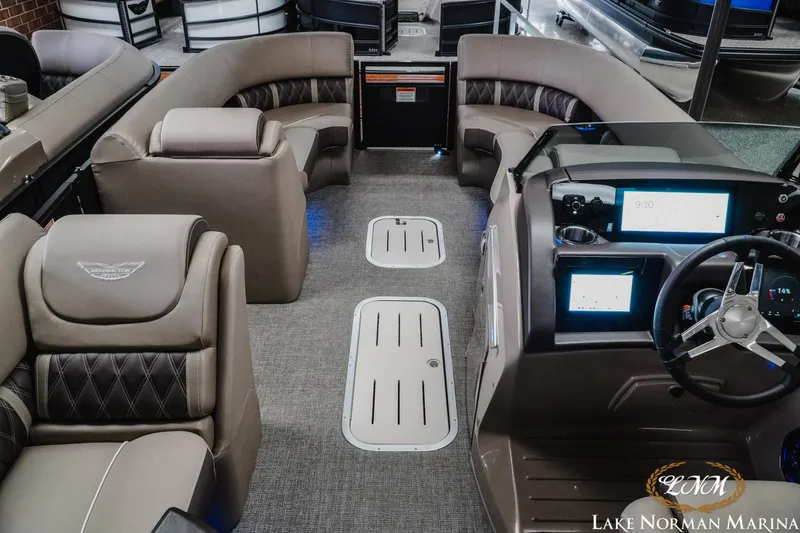 Slide: The Image of 2025 Bennington 24LXSSB pontoon boat interior with luxurious seating and modern dashboard at Lake Norman Marina. - 10