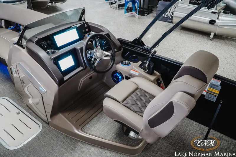 Slide: The Image of 2025 Bennington 24LXSSB boat interior with modern dashboard and comfortable seating at Lake Norman Marina. - 11