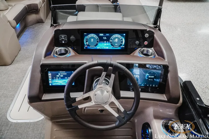 Slide: The Image of 2025 Bennington 24LXSSB boat dashboard with modern digital displays and steering wheel. - 12