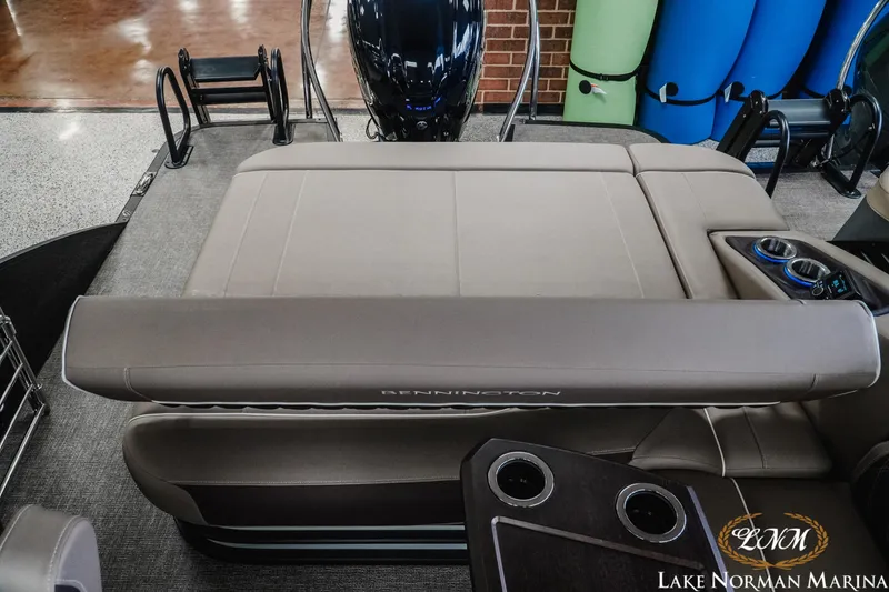 Slide: The Image of 2025 Bennington 24LXSSB boat interior with luxurious seating and cup holders at Lake Norman Marina. - 18