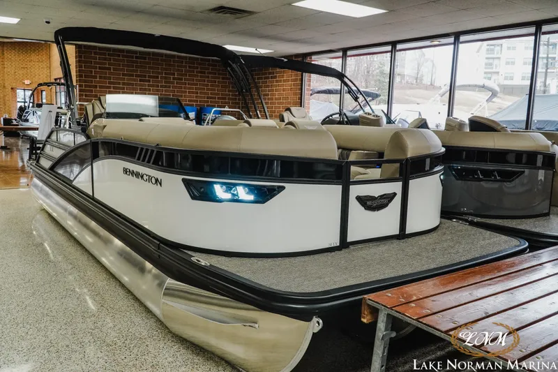 Slide: The Image of 2025 Bennington 24LXSSB pontoon boat displayed indoors at Lake Norman Marina. - 3
