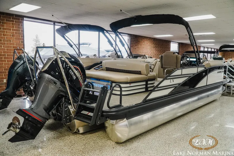 Slide: The Image of 2025 Bennington 24LXSSB pontoon boat displayed at Lake Norman Marina showroom. - 5