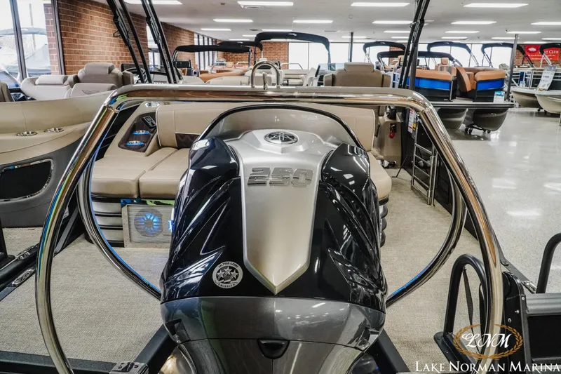Slide: The Image of 2025 Bennington 24LXSSB pontoon boat displayed at Lake Norman Marina showroom. - 6