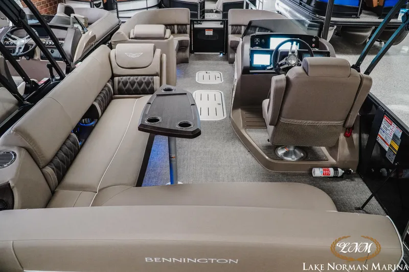 Slide: The Image of 2025 Bennington 24LXSSB pontoon boat interior with luxurious seating and modern dashboard. - 9