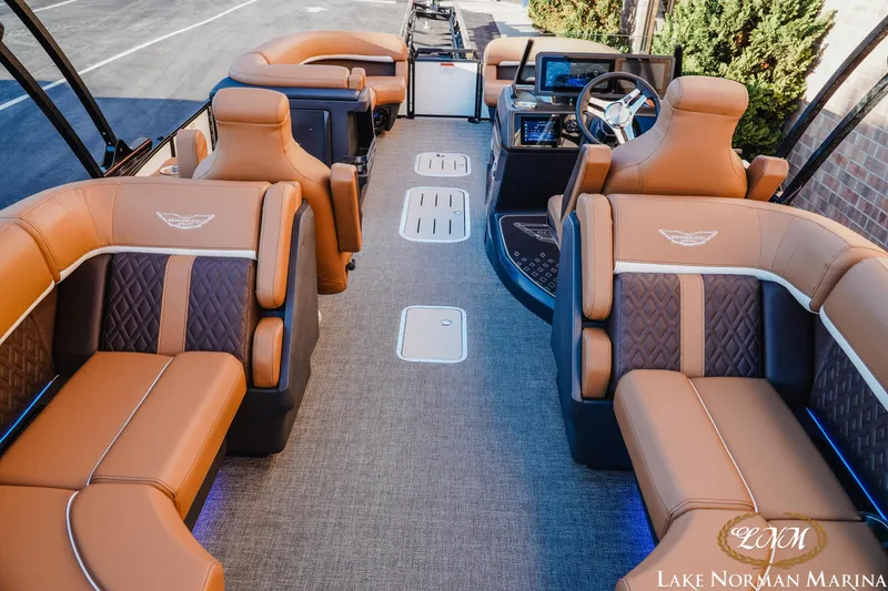 Slide: The Image of Luxurious interior of 2025 Bennington 24MFB pontoon boat with plush seating and modern dashboard. - 4