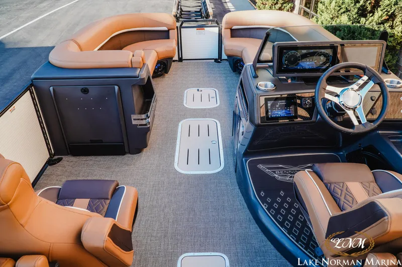 Slide: The Image of 2025 Bennington 24MFB boat interior with luxurious seating and modern dashboard at Lake Norman Marina. - 6
